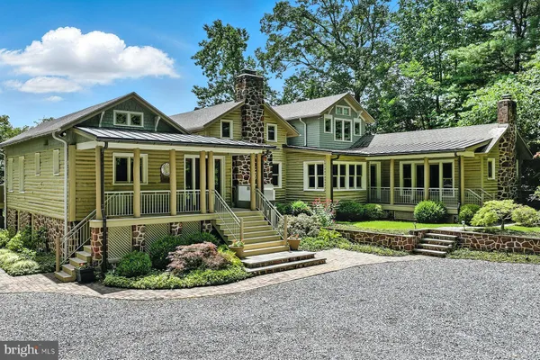 a front view of a house with a yard and outdoor seating