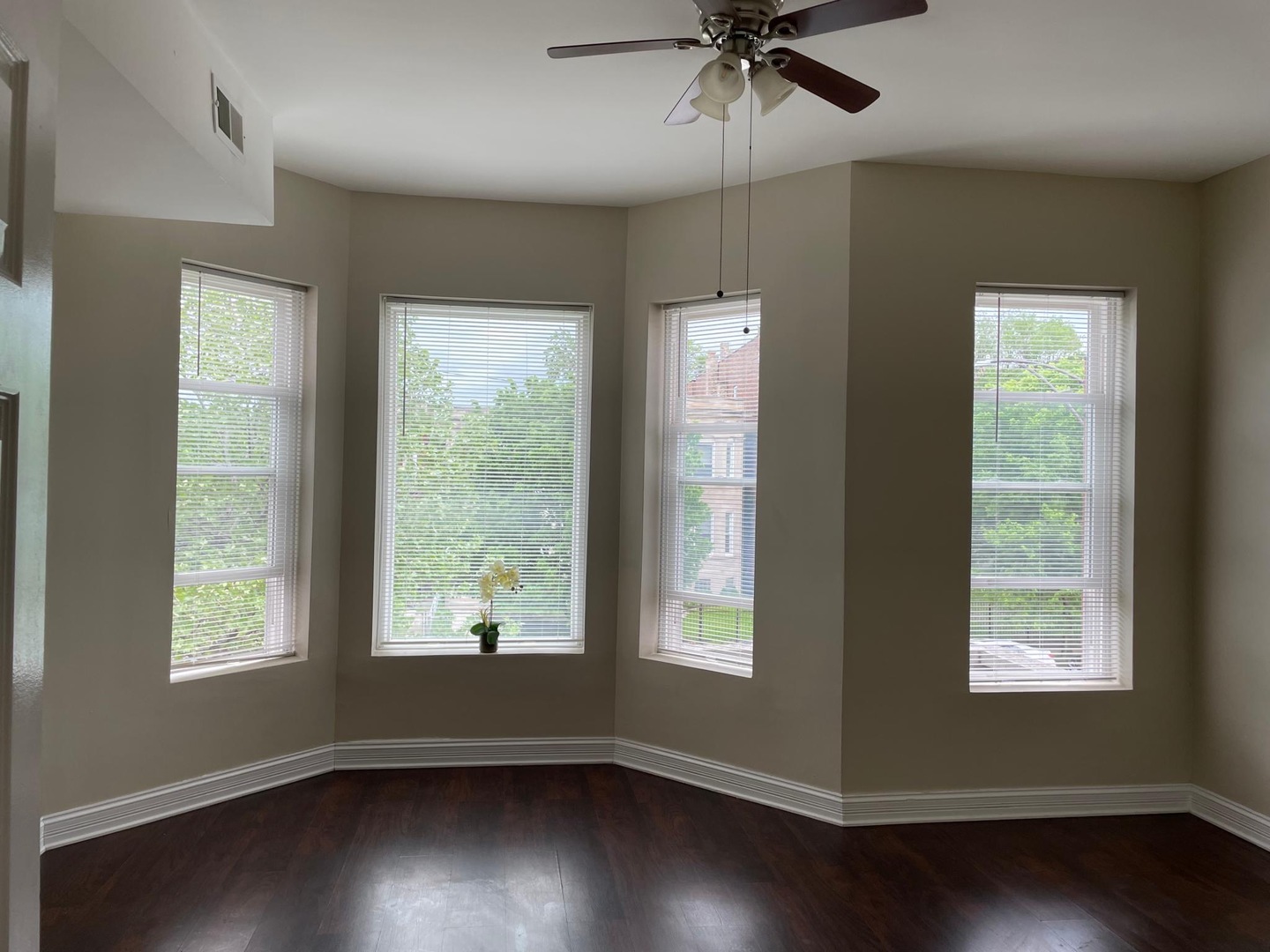 5616 South Indiana Avenue, Unit 2 Chicago, IL 60637 - Photo 4 of 14 a view of an empty room with wooden floor and a window