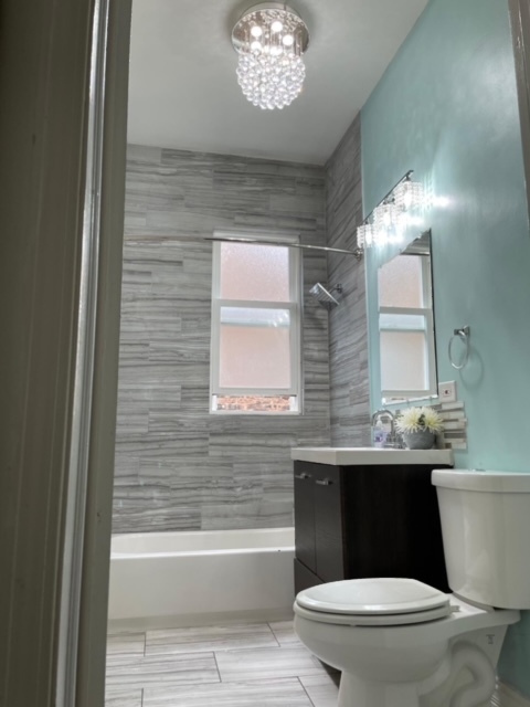 5616 South Indiana Avenue, Unit 2 Chicago, IL 60637 - Photo 7 of 14 a bathroom with a toilet a sink and a bathtub