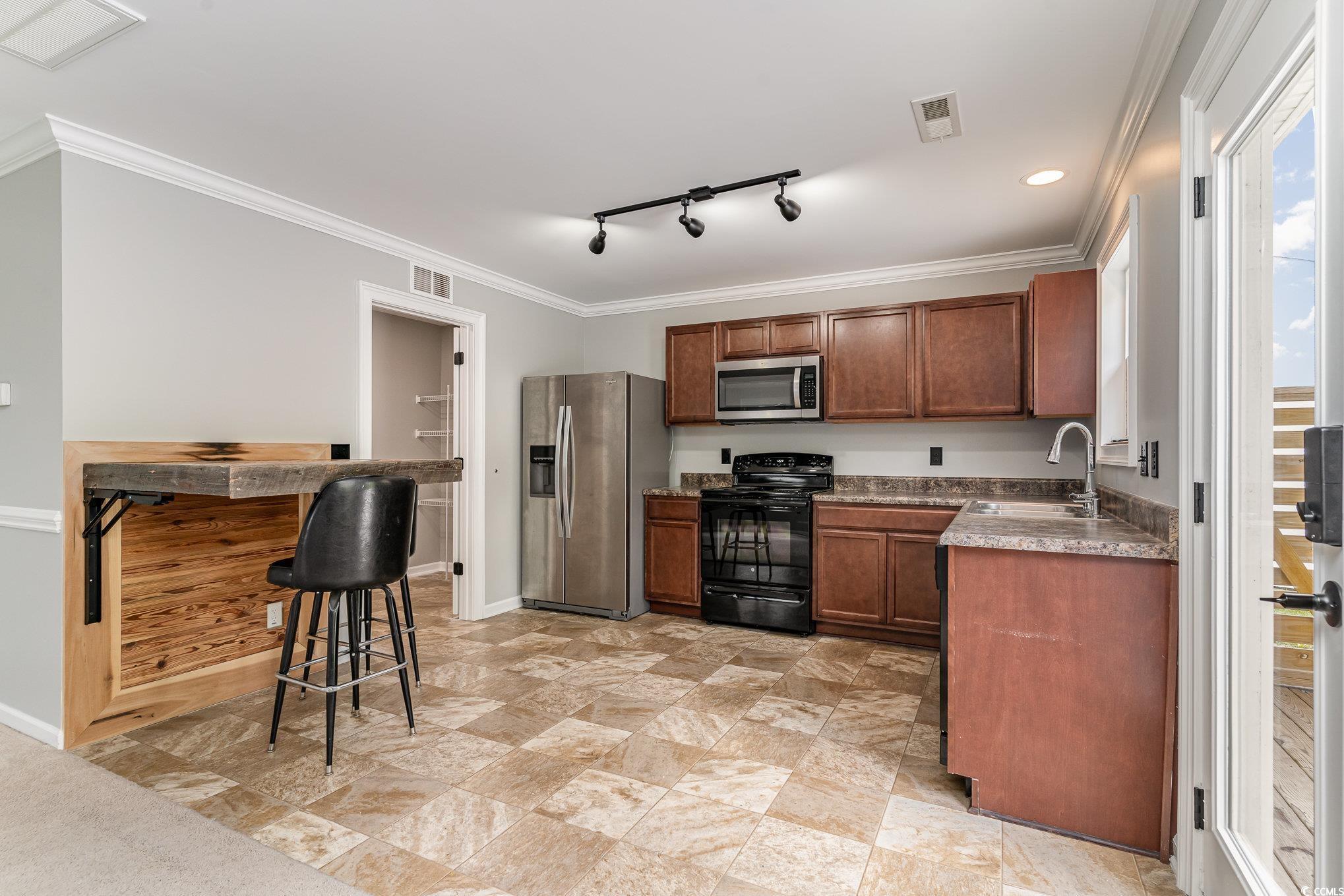 113 Winding Path Drive Loris, SC 29569 - Photo 11 of 36 Kitchen with stainless steel appliances, visible vents, baseboards, and a sink