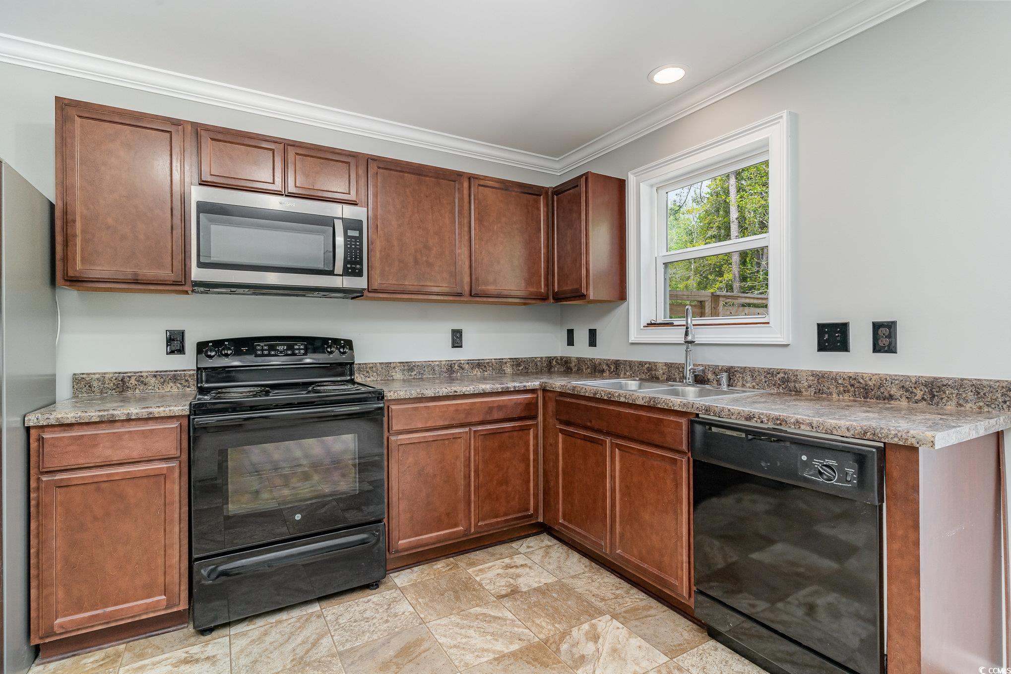 113 Winding Path Drive Loris, SC 29569 - Photo 14 of 36 Kitchen featuring ornamental molding, stone finish flooring, black appliances, recessed lighting, and a sink