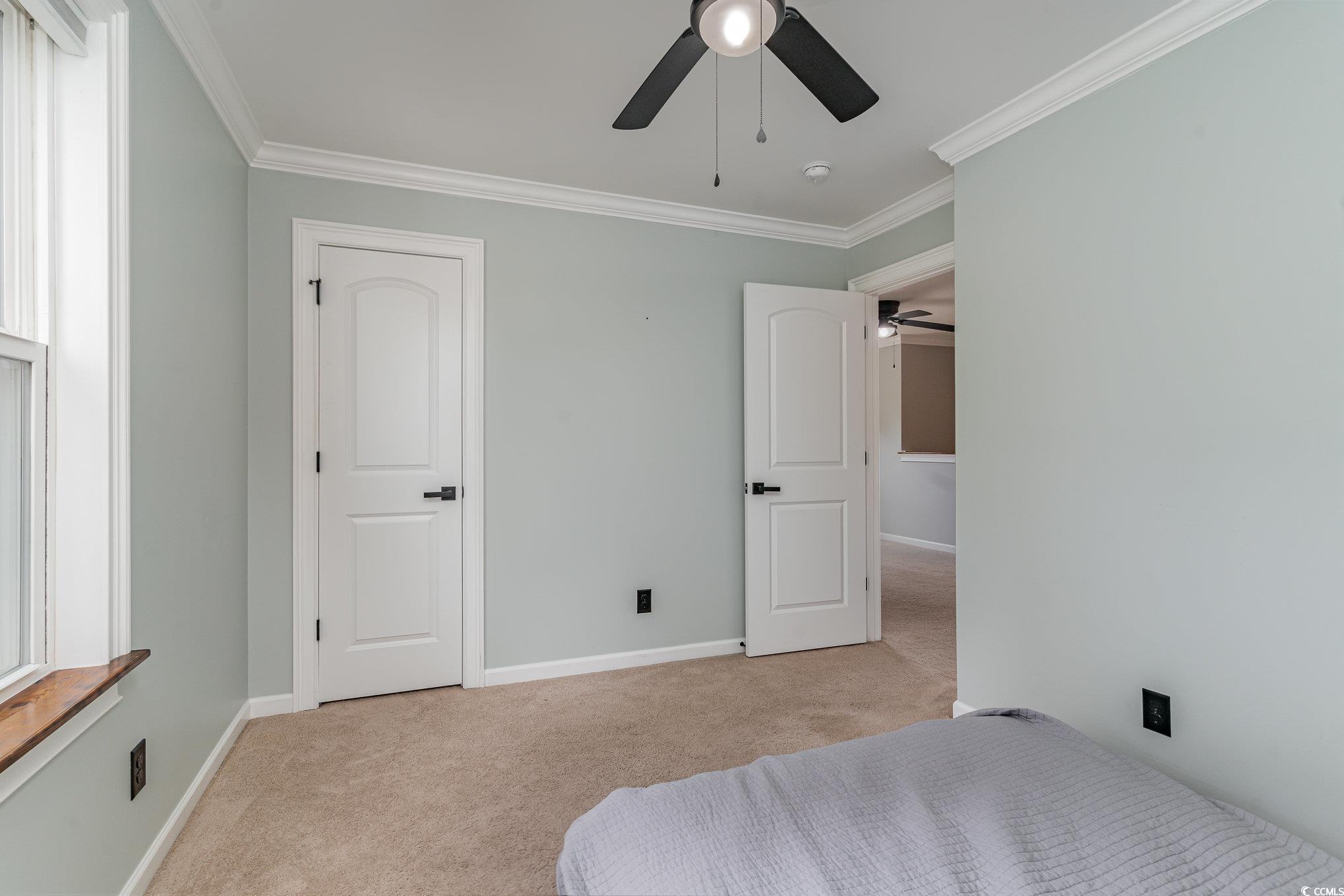 113 Winding Path Drive Loris, SC 29569 - Photo 20 of 36 Bedroom with light carpet, crown molding, a ceiling fan, and baseboards