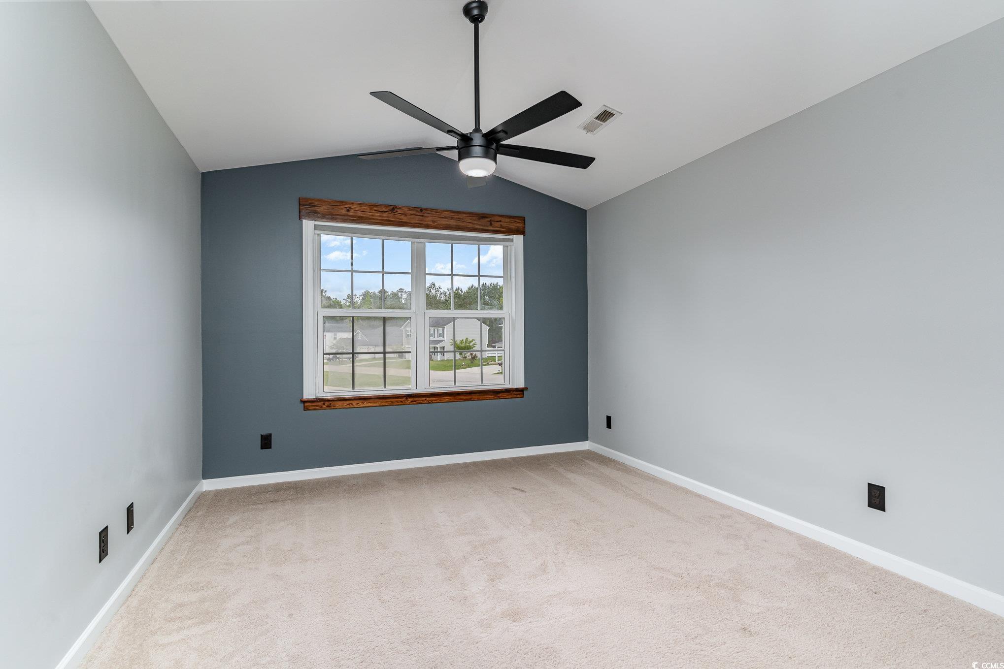113 Winding Path Drive Loris, SC 29569 - Photo 22 of 36 Spare room with ceiling fan, visible vents, carpet flooring, lofted ceiling, and baseboards