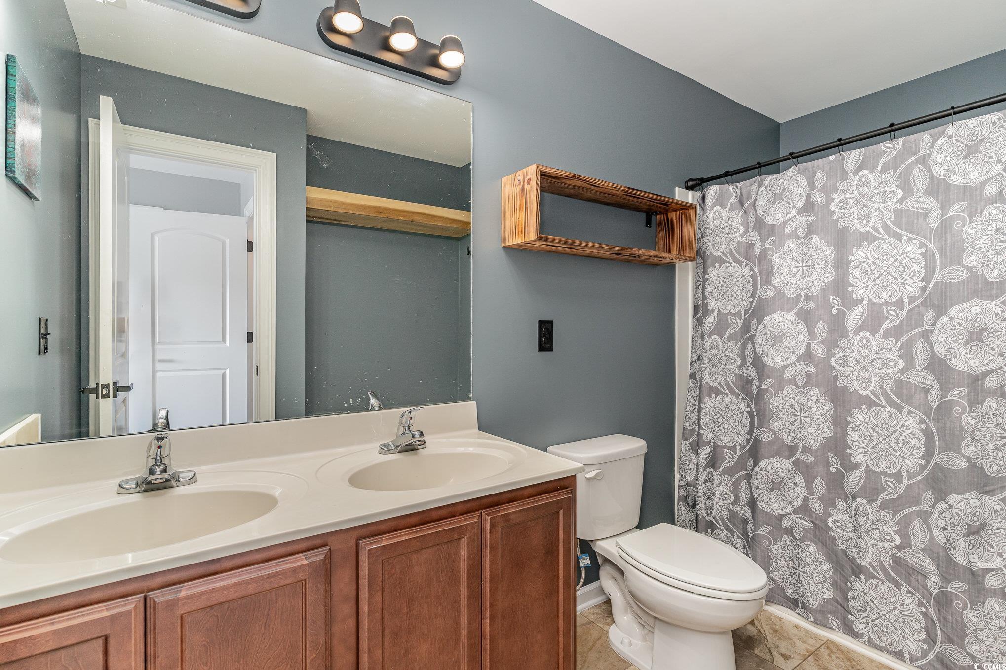 113 Winding Path Drive Loris, SC 29569 - Photo 25 of 36 Bathroom with a sink, toilet, double vanity, and tile patterned flooring
