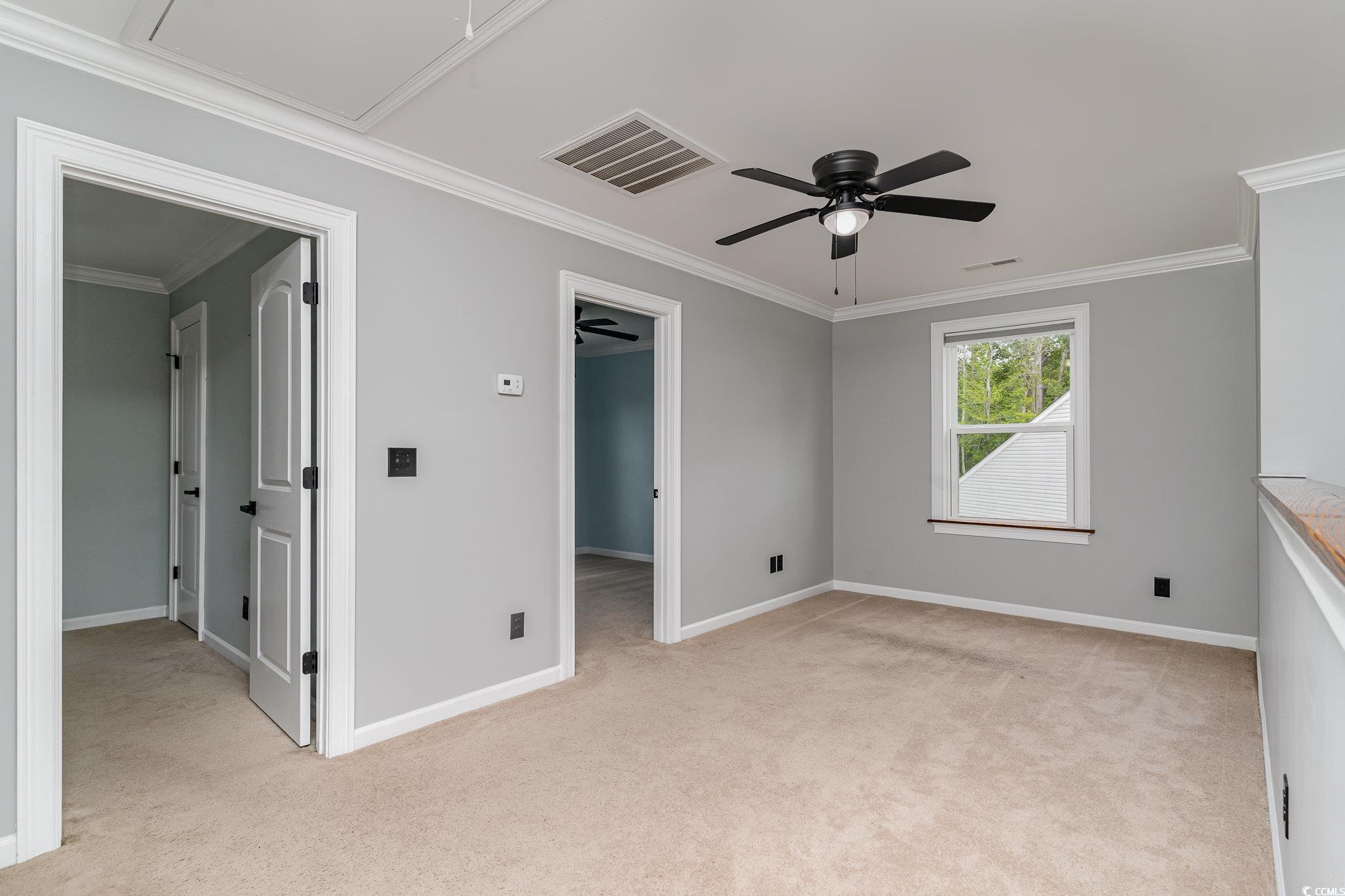 113 Winding Path Drive Loris, SC 29569 - Photo 26 of 36 Unfurnished bedroom featuring baseboards, light carpet, attic access, a walk in closet, and visible vents