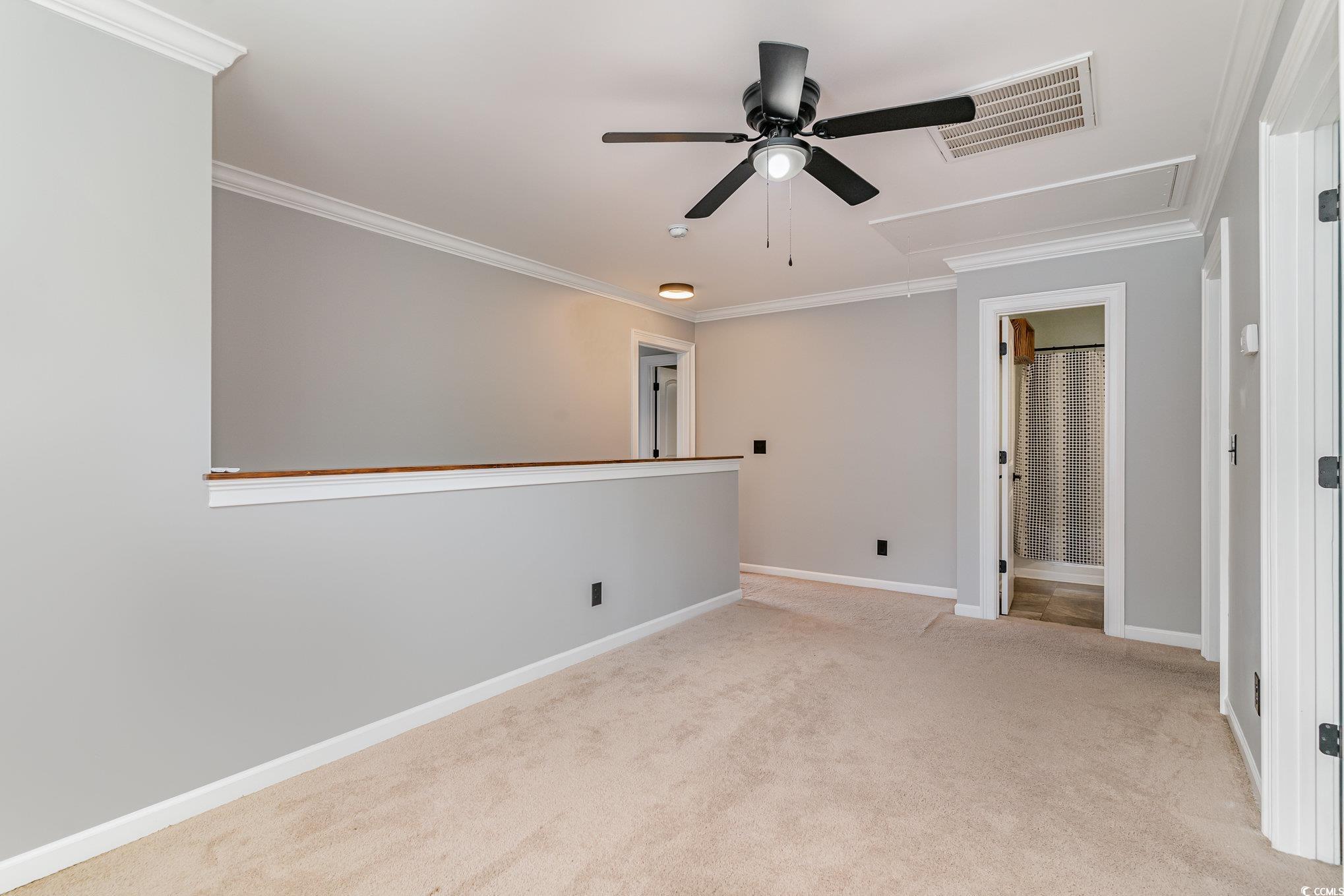 113 Winding Path Drive Loris, SC 29569 - Photo 27 of 36 Carpeted spare room with baseboards, attic access, crown molding, visible vents, and ceiling fan