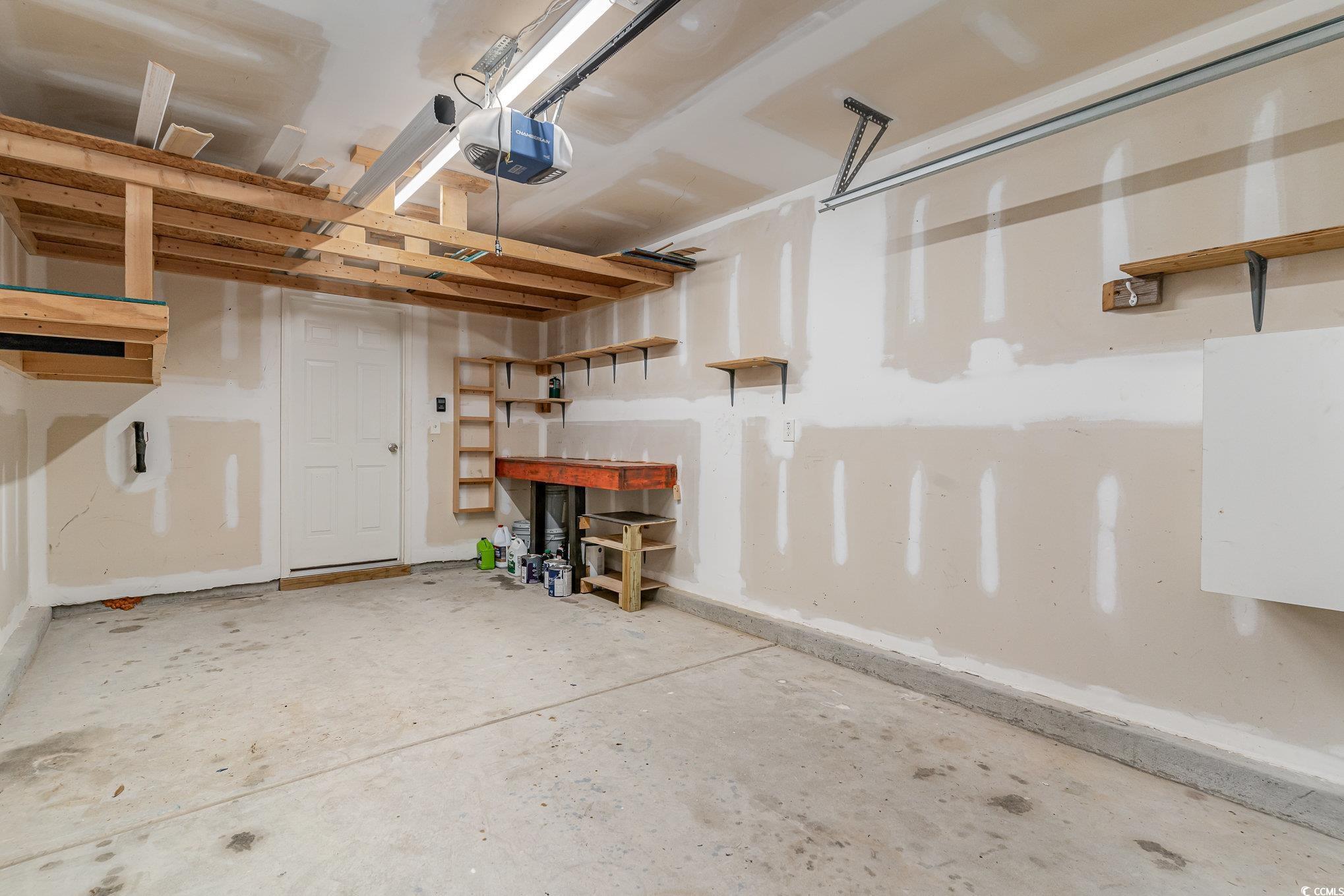 113 Winding Path Drive Loris, SC 29569 - Photo 29 of 36 Garage featuring a garage door opener and a workshop area