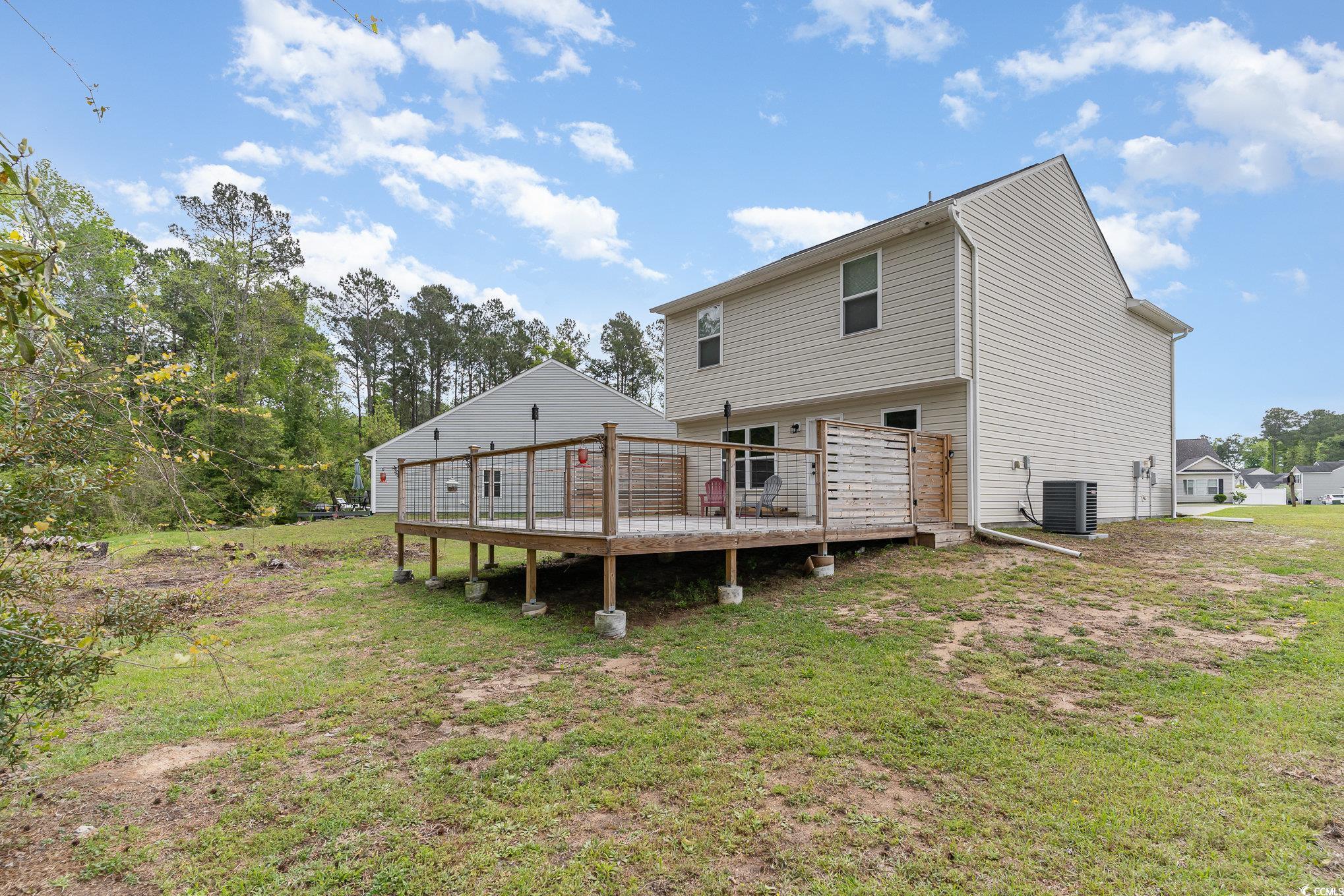 113 Winding Path Drive Loris, SC 29569 - Photo 33 of 36 Back of house featuring central air condition unit, a deck, and a lawn