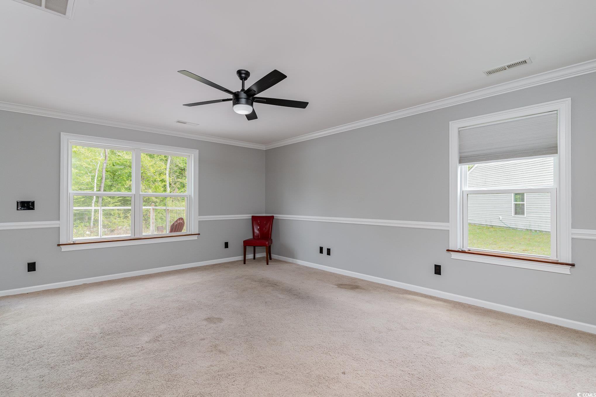 113 Winding Path Drive Loris, SC 29569 - Photo 6 of 36 Empty room featuring crown molding, ceiling fan, baseboards, and visible vents