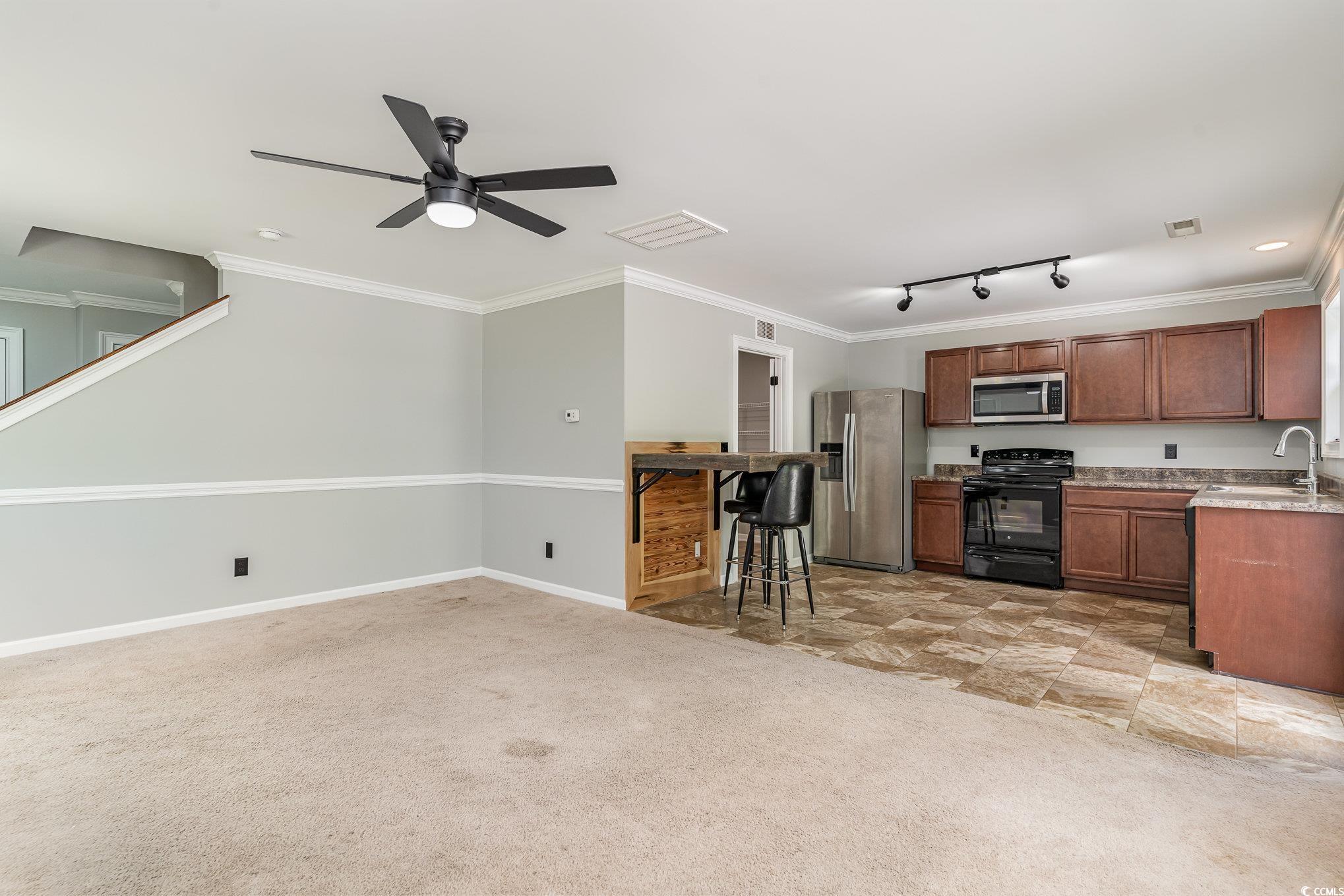 113 Winding Path Drive Loris, SC 29569 - Photo 9 of 36 Kitchen with visible vents, a sink, ceiling fan, appliances with stainless steel finishes, and light colored carpet