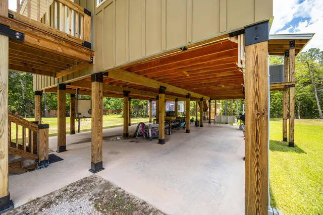 a view of a porch with furniture and floor to ceiling window