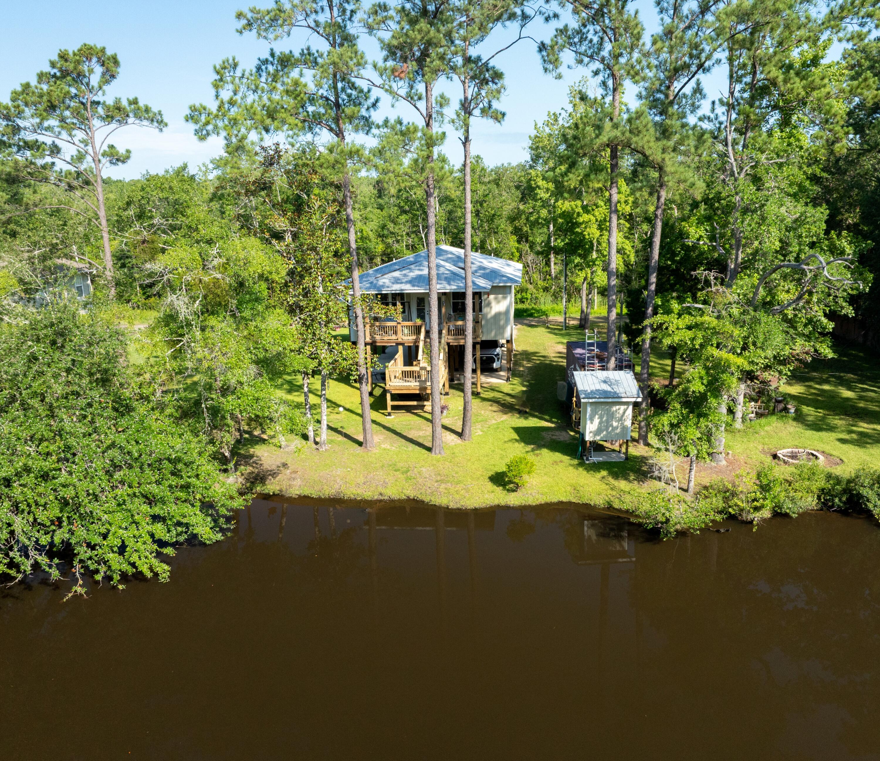 158 Johns Lane Freeport, FL 32439 - Photo 31 of 36 a view of a lake with a house in the background
