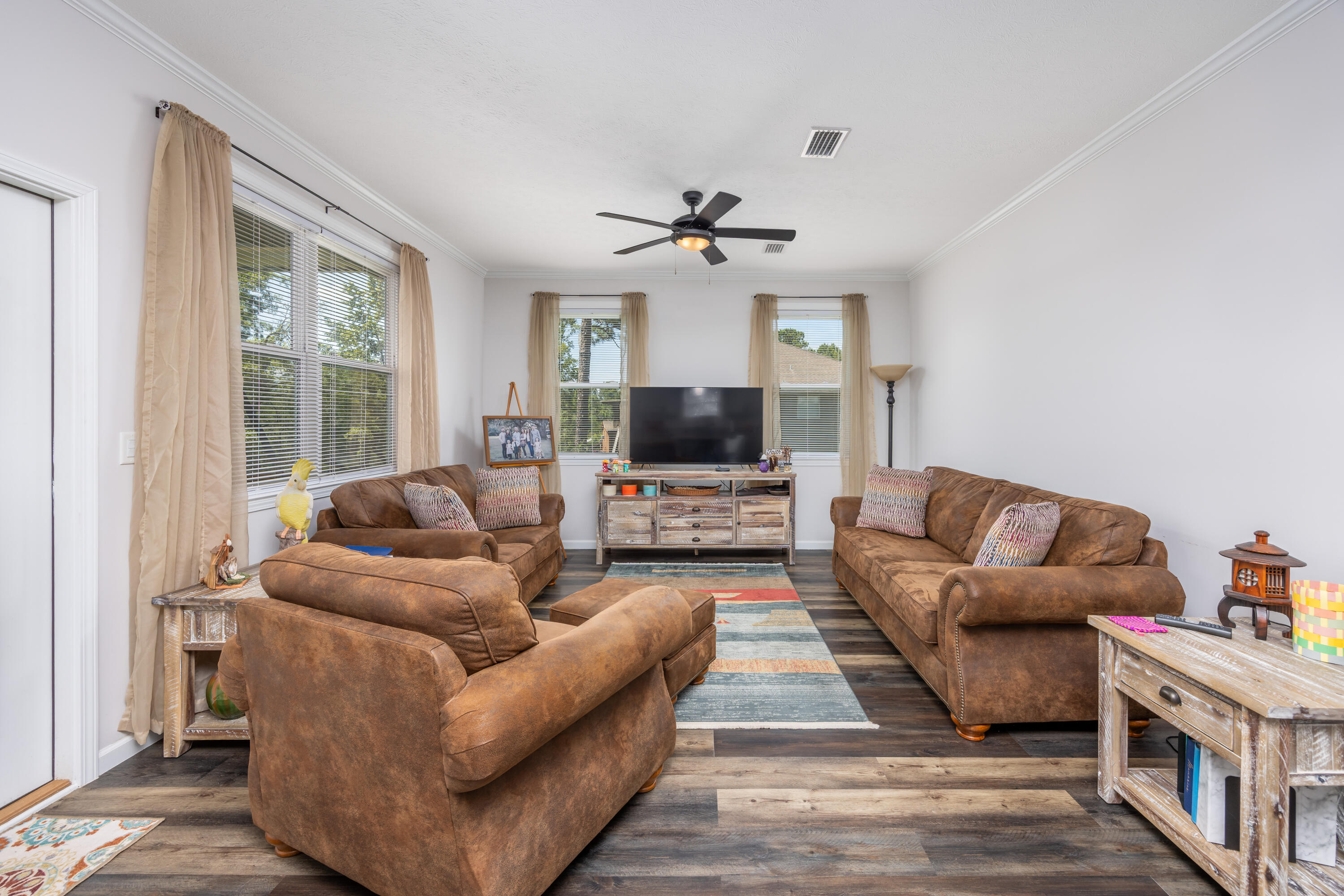 158 Johns Lane Freeport, FL 32439 - Photo 7 of 36 a living room with furniture a flat screen tv and a fireplace