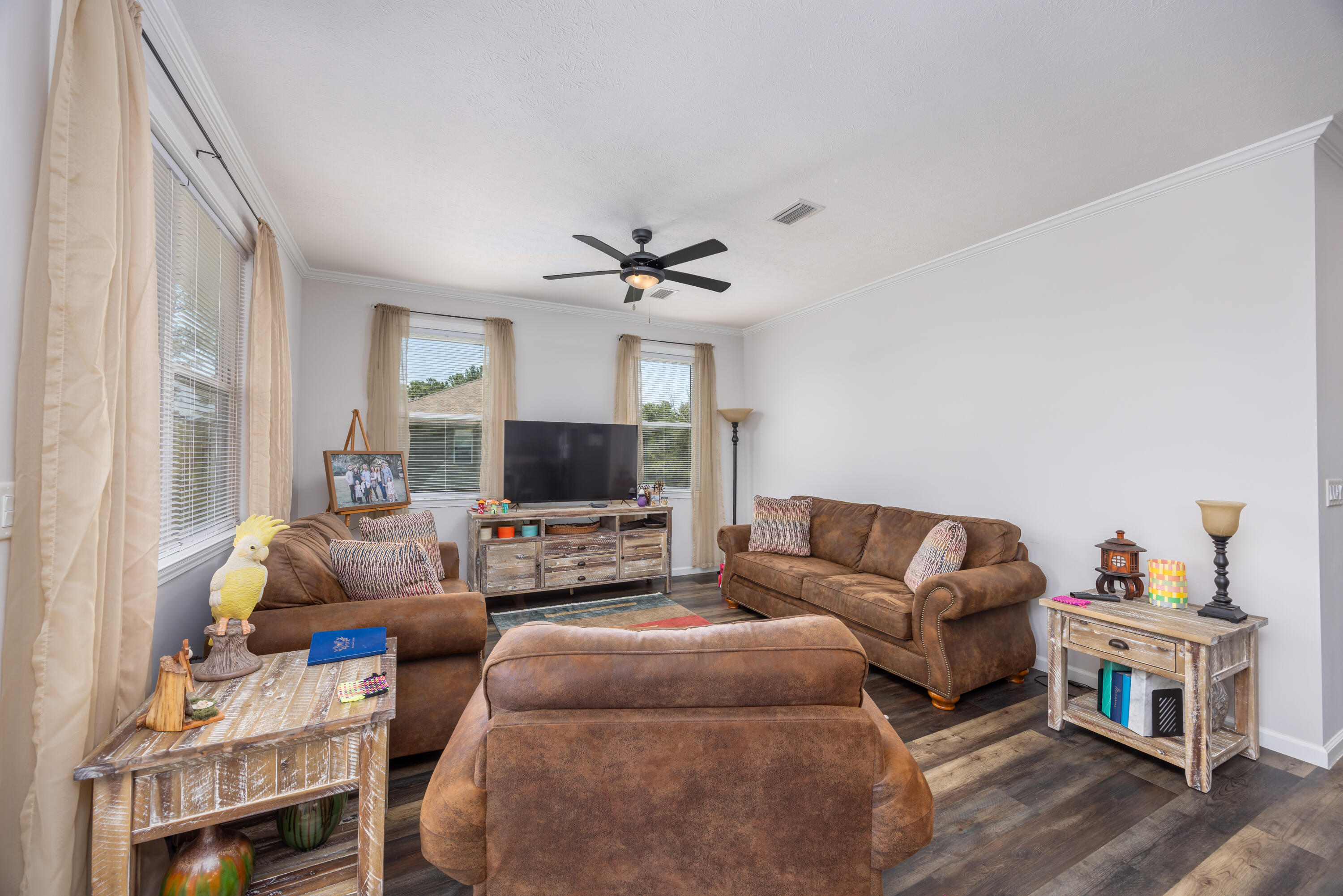 158 Johns Lane Freeport, FL 32439 - Photo 8 of 36 a living room with furniture a flat screen tv and a window