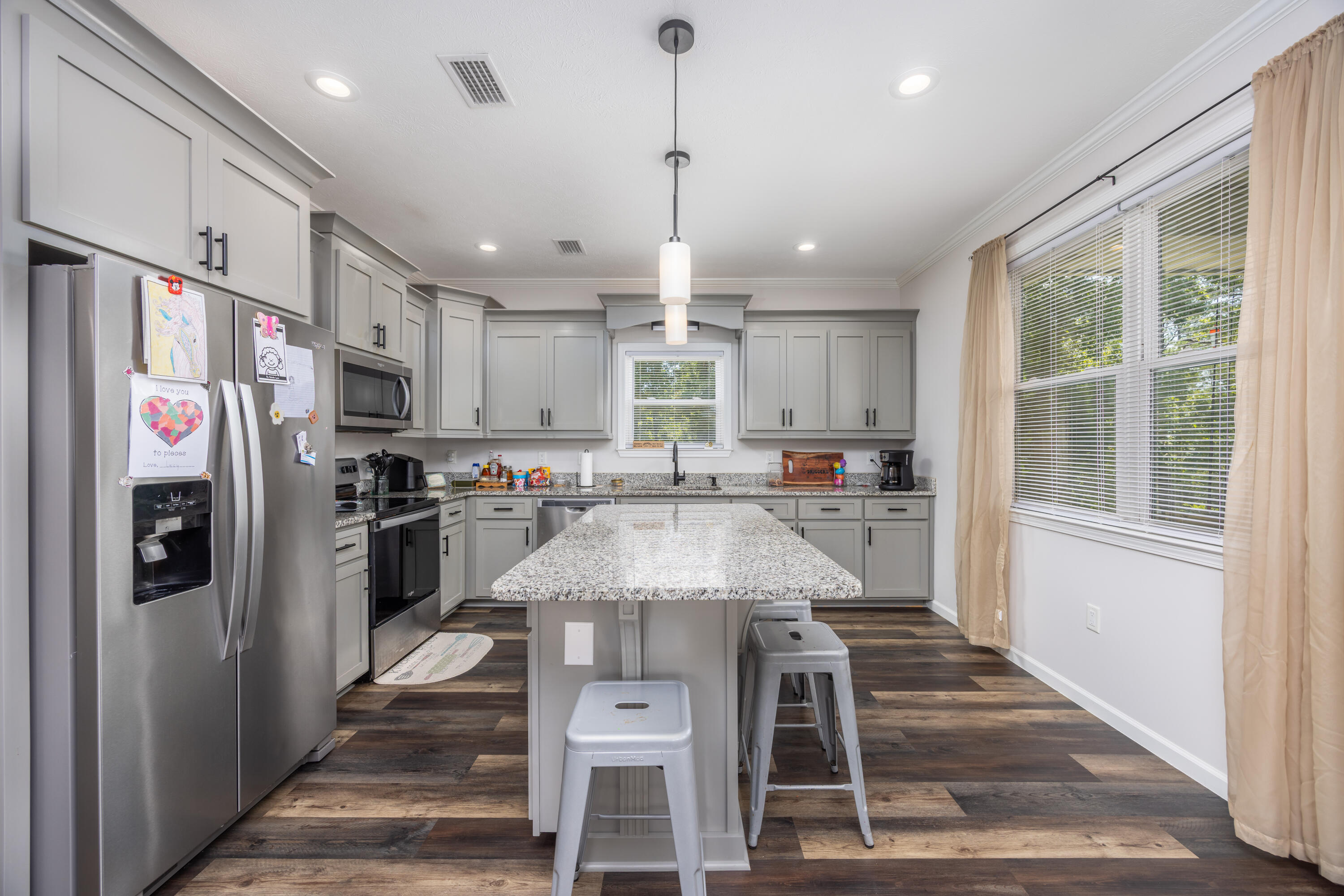 158 Johns Lane Freeport, FL 32439 - Photo 10 of 36 a kitchen with stainless steel appliances kitchen island granite countertop a refrigerator and a stove top oven