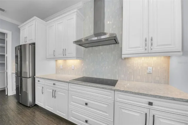 a view of a livingroom with wooden floor and windows