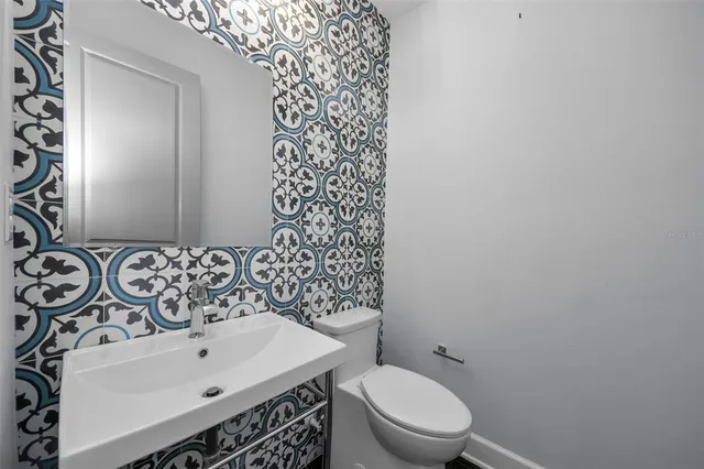 a view of an empty room with wooden floor and staircase