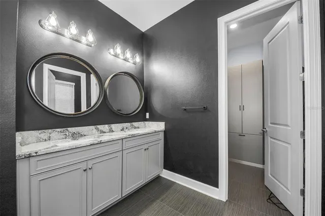 a view of an empty room with cabinet and wooden floor