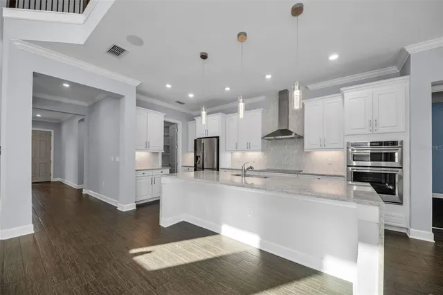 a kitchen with stainless steel appliances granite countertop a sink and cabinets