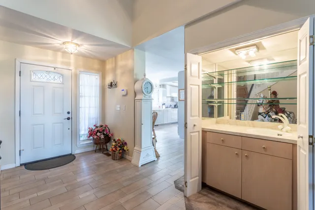 a bathroom with a granite countertop tub a sink and a large mirror