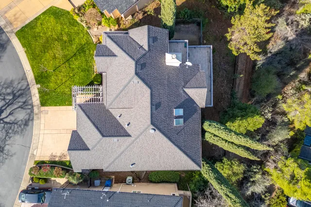 an aerial view of residential houses with swimming pool and outdoor space