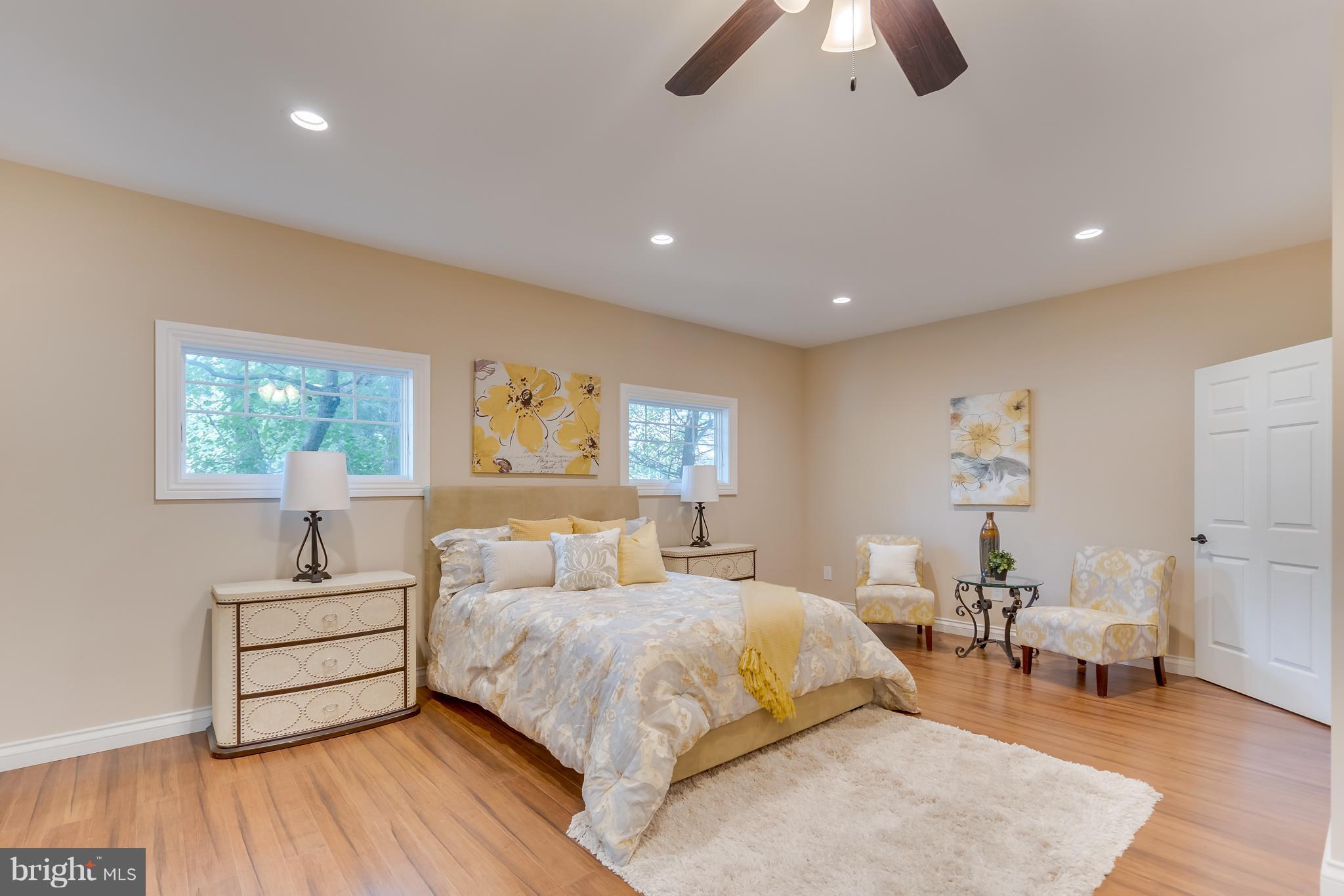 1415 Julia Avenue McLean, VA 22101 - Photo 12 of 30 a spacious bedroom with a bed and a couch
