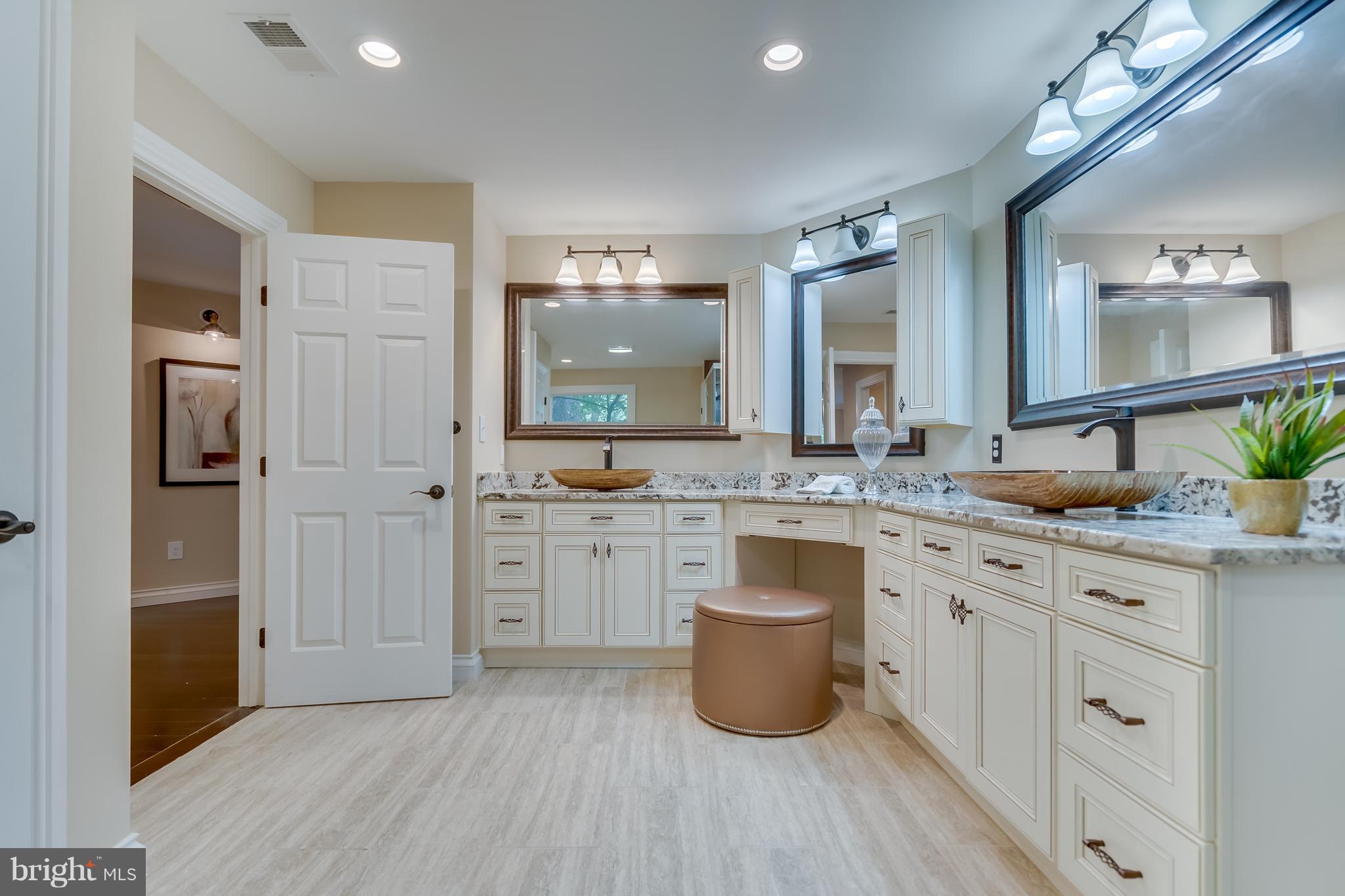 1415 Julia Avenue McLean, VA 22101 - Photo 21 of 30 a large bathroom with a granite countertop double vanity sink a mirror and a shower