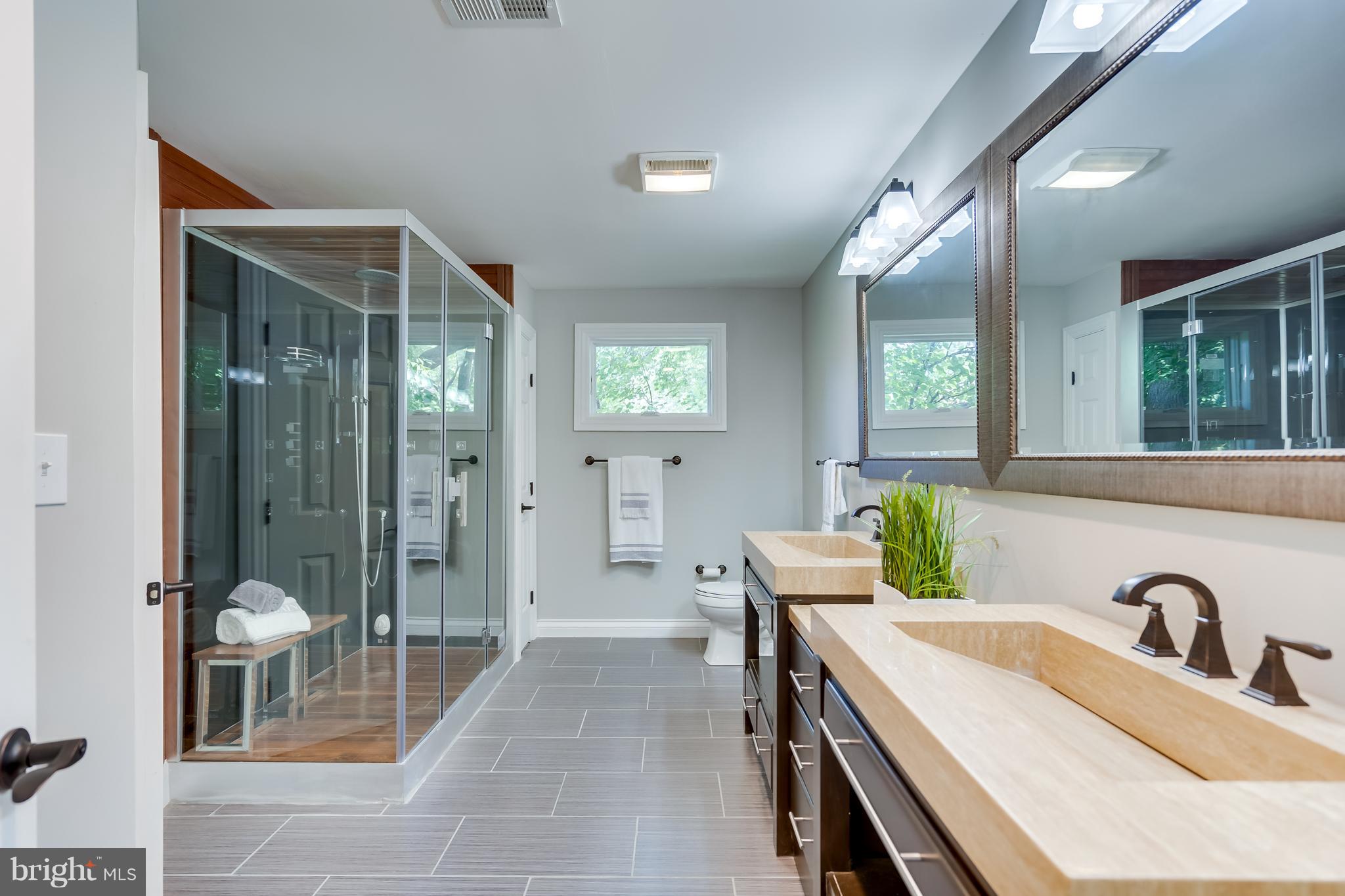 1415 Julia Avenue McLean, VA 22101 - Photo 24 of 30 a spacious bathroom with a granite countertop sink mirror and shower