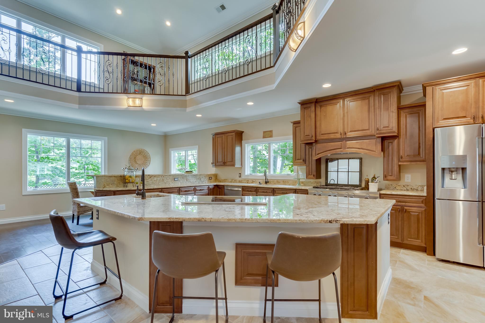 1415 Julia Avenue McLean, VA 22101 - Photo 5 of 30 a kitchen with stainless steel appliances granite countertop a stove a refrigerator a sink a dining table and chairs with wooden floor