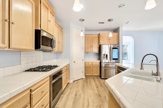 a kitchen with a stove kitchen island and couches