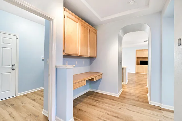 an empty room that has a wooden cupboard