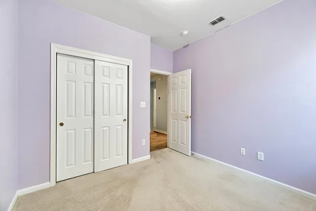 a view of an empty room with a ceiling fan