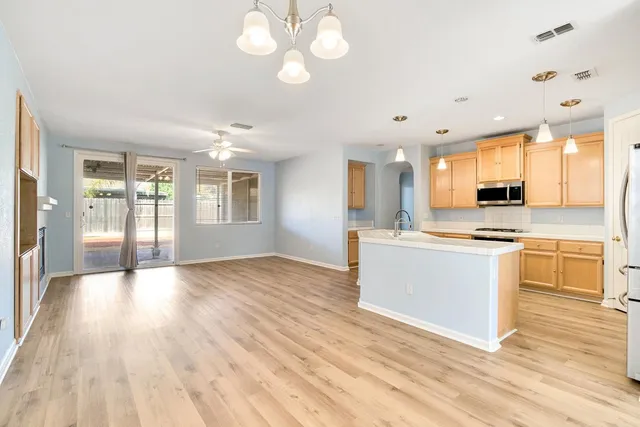 a view of a kitchen with a sink a kitchen counter space and a refrigerator