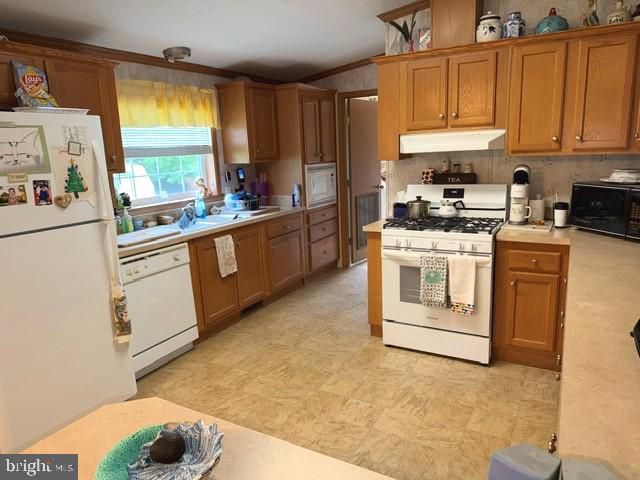 4938 Old Trappe Road Trappe, MD 21673 - Photo 7 of 10 a kitchen with stainless steel appliances granite countertop a stove a sink and a refrigerator