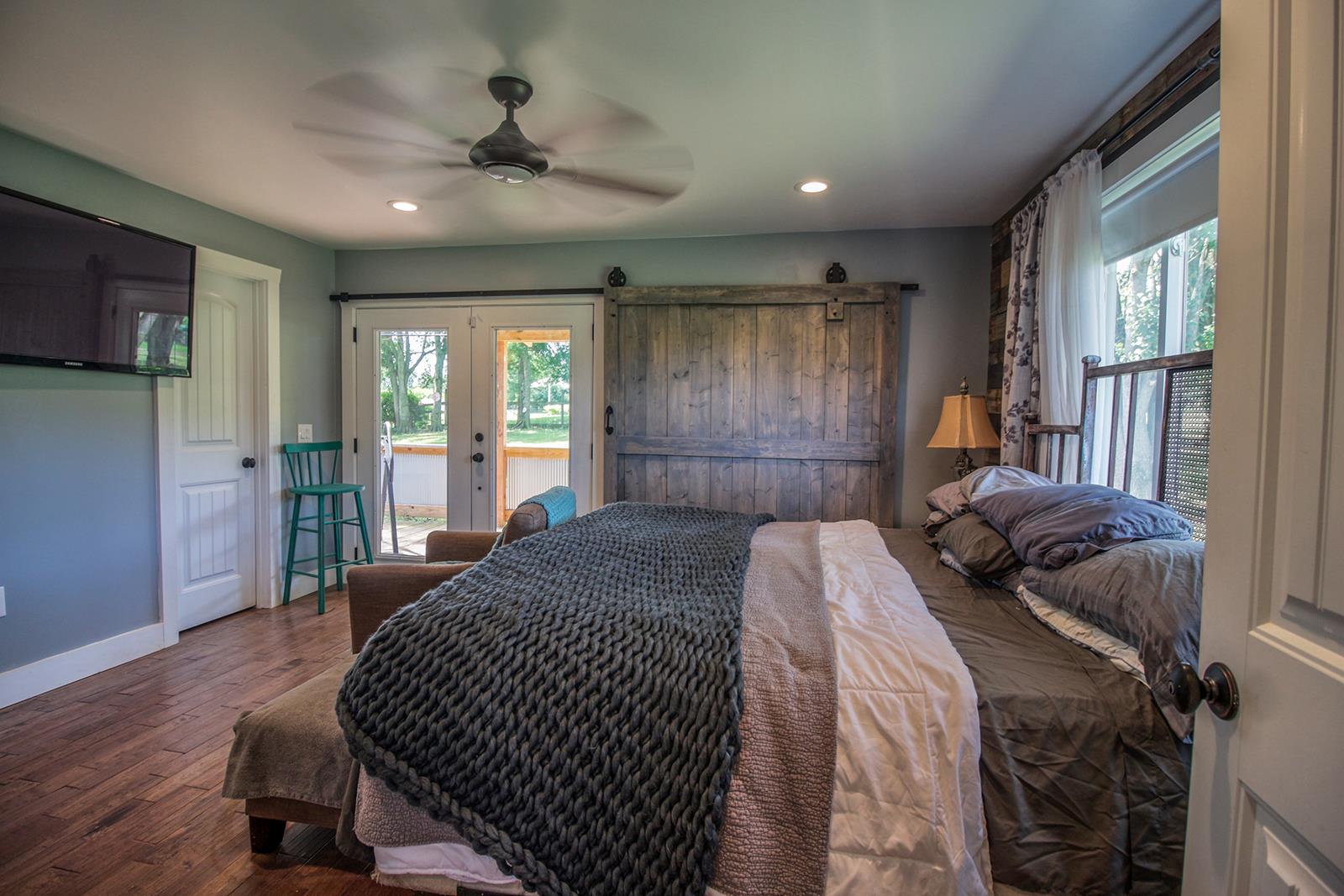 444 Canaan Road Columbia, TN 38401 - Photo 17 of 30 Master bedroom with barn door that can cover your patio doors leading to your side deck!
