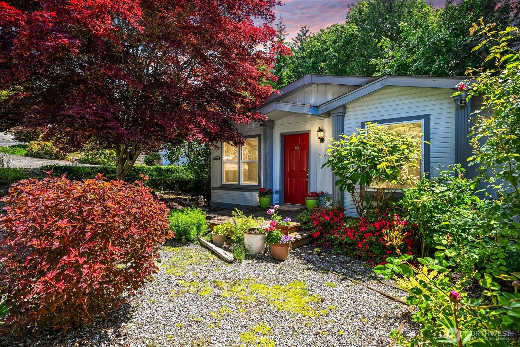 a front view of a house with a yard garage and outdoor seating