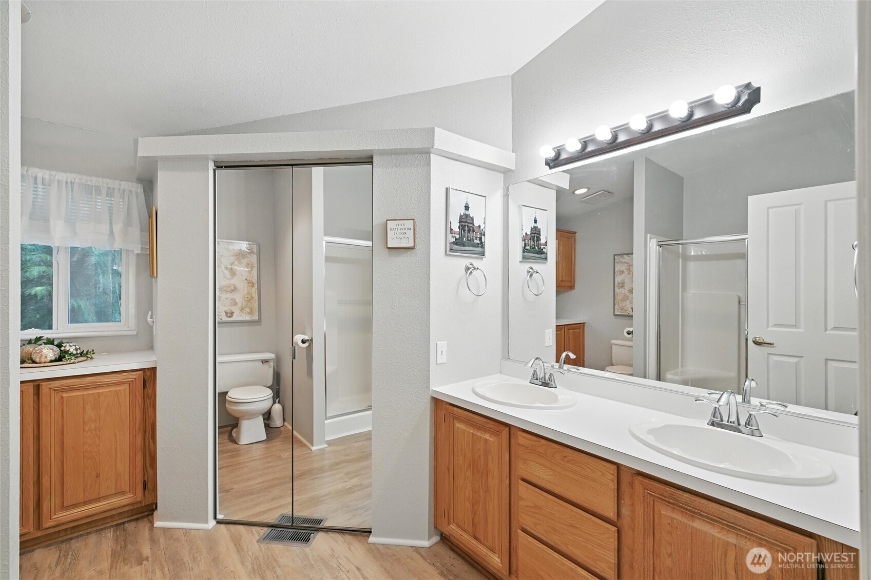 4949 Samish Way, Unit 56 Bellingham, WA 98229 - Photo 12 of 33 a bathroom with a double vanity sink and mirror with shower