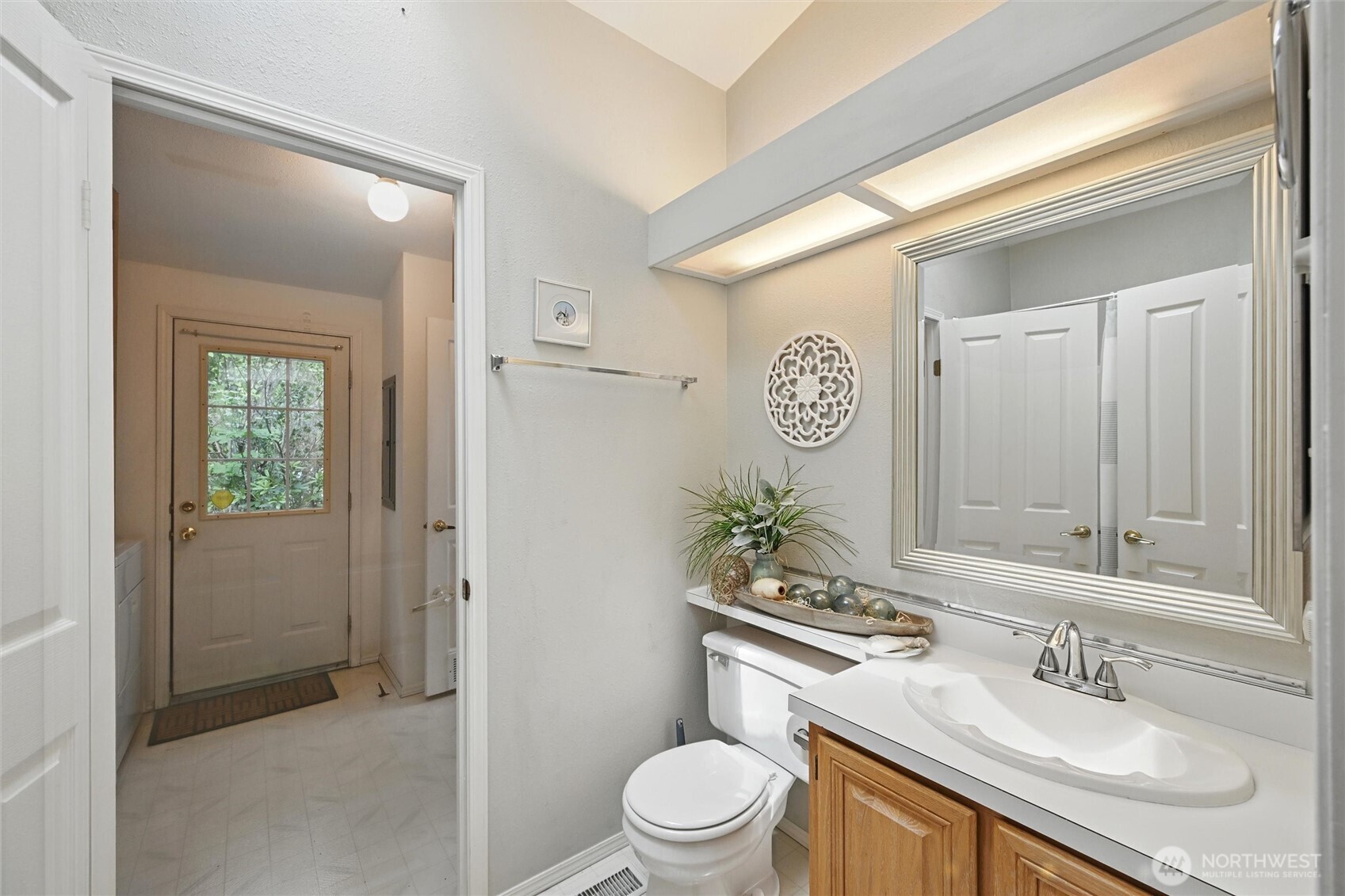 4949 Samish Way, Unit 56 Bellingham, WA 98229 - Photo 16 of 33 a bathroom with a toilet sink and mirror