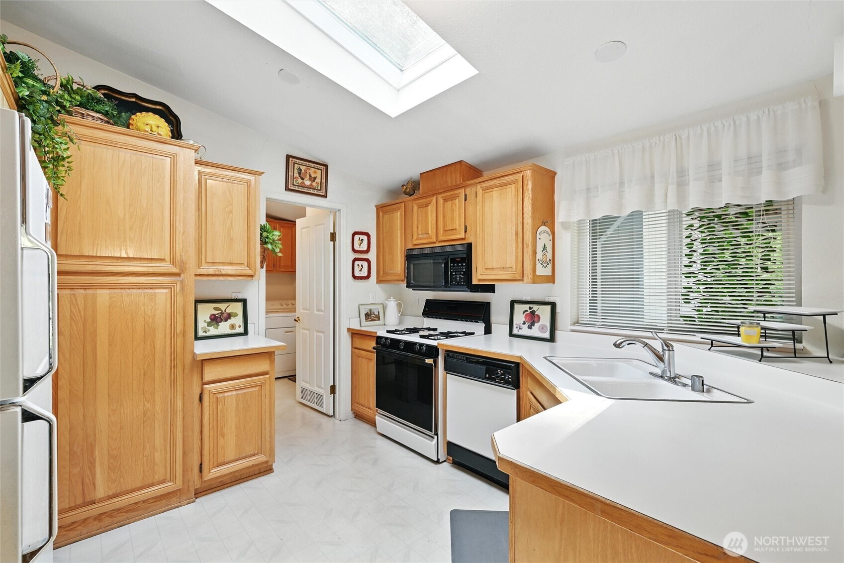 4949 Samish Way, Unit 56 Bellingham, WA 98229 - Photo 18 of 33 a kitchen with stainless steel appliances a refrigerator sink and microwave