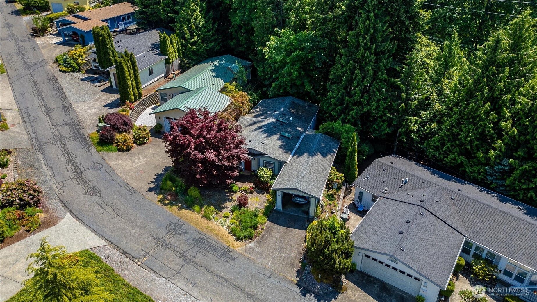 4949 Samish Way, Unit 56 Bellingham, WA 98229 - Photo 2 of 33 an aerial view of a house with a yard and garden