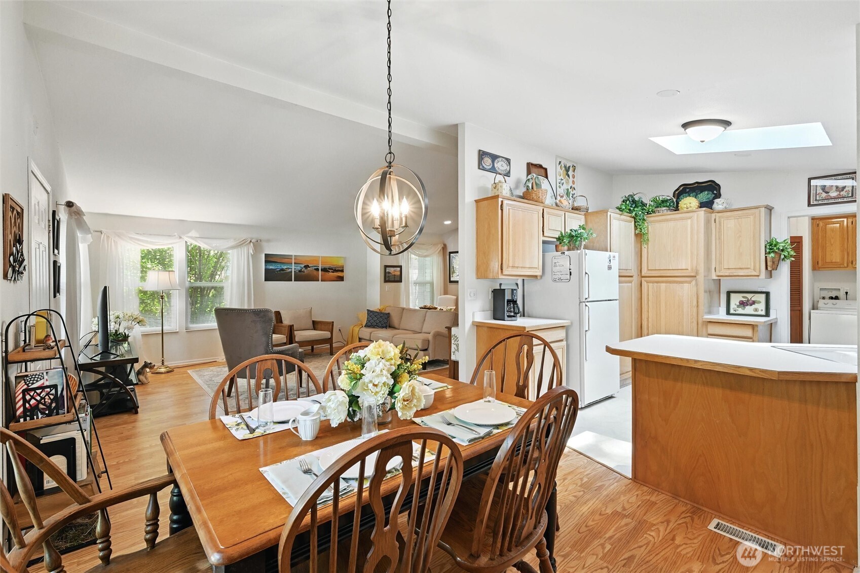 4949 Samish Way, Unit 56 Bellingham, WA 98229 - Photo 22 of 33 a dining room with furniture a chandelier and wooden floor