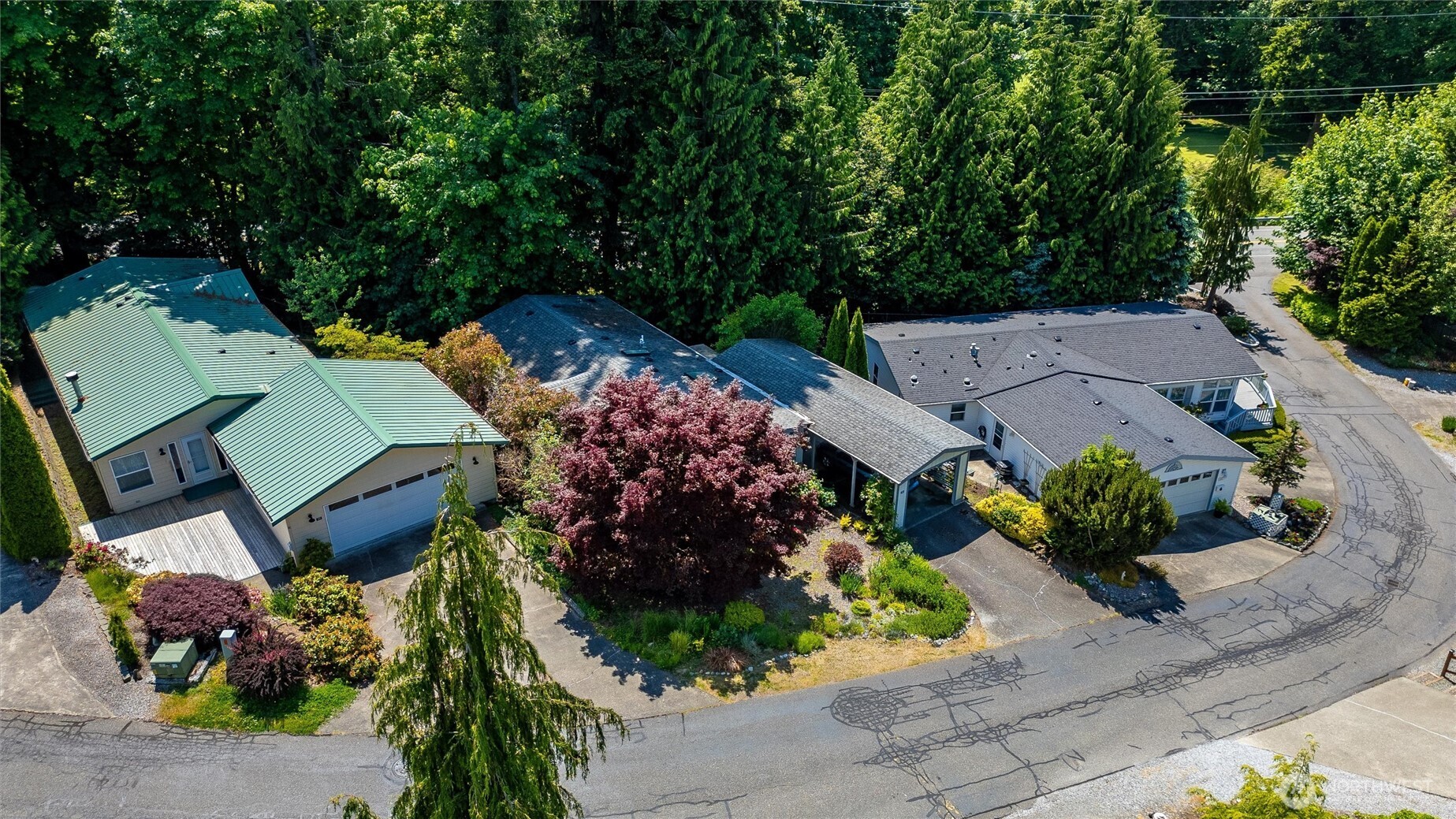 4949 Samish Way, Unit 56 Bellingham, WA 98229 - Photo 3 of 33 an aerial view of a house with a yard and garden
