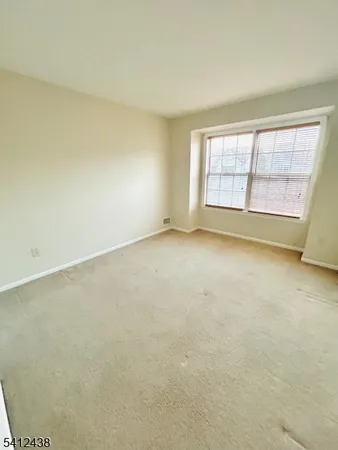 an empty room with a empty space and windows