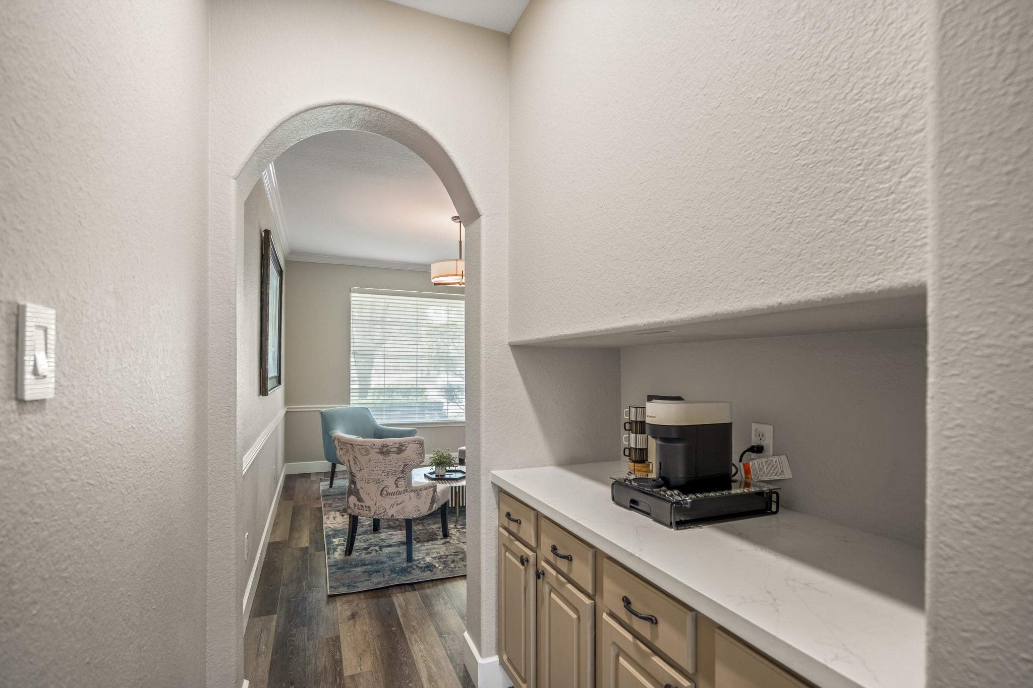 5835 Pinelake Crossing Drive Spring, TX 77379 - Photo 16 of 50 Tucked just off the kitchen, a built-in coffee bar creates a convenient spot for morning routines or extra prep space, with storage below and open shelving above. Set beneath the stairs, this area flows through the arched opening into the front flex space beyond.
