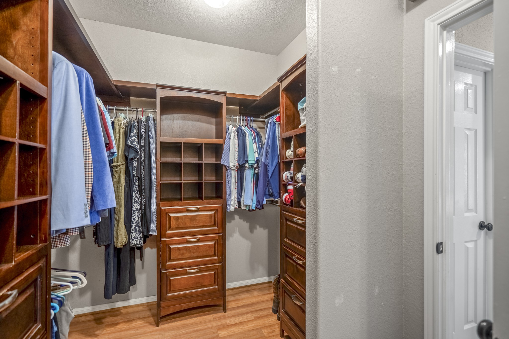 5835 Pinelake Crossing Drive Spring, TX 77379 - Photo 20 of 50 The primary closet is impressively sized, outfitted with custom built-ins that make staying organized feel effortless. Dedicated hanging space, drawers, and shelving create room for everything, blending function with a polished, tailored feel.