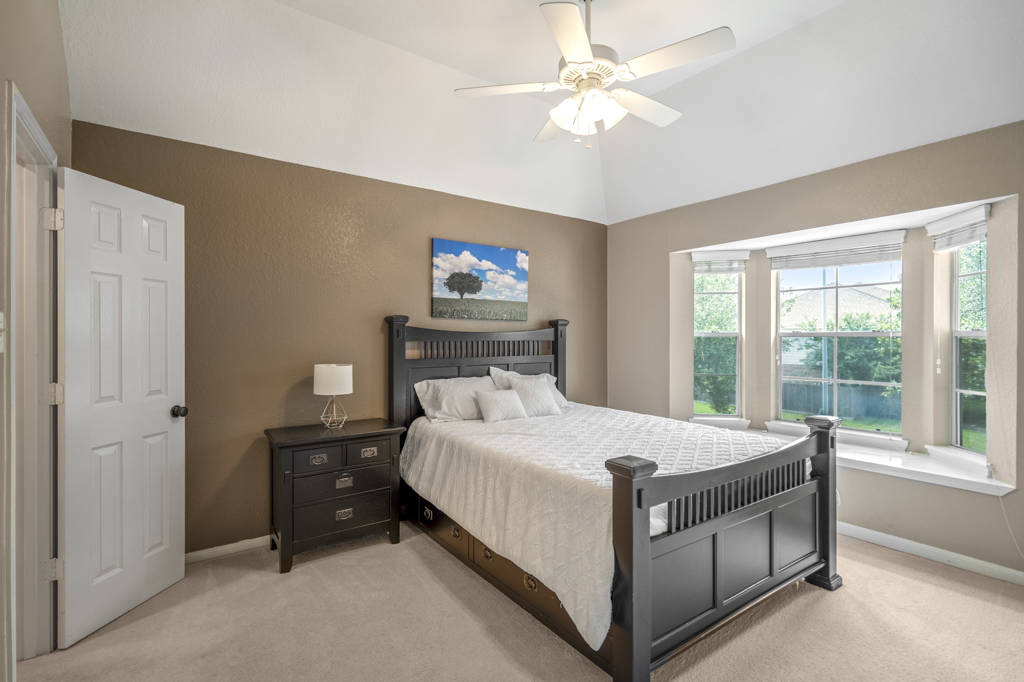 5835 Pinelake Crossing Drive Spring, TX 77379 - Photo 24 of 50 Near the game room, this upstairs bedroom suite is set up beautifully for guests, featuring a bay window overlooking the front that brings in soft natural light and a bit of extra space. The walk-in closet connects through to its own ensuite bathroom, offering added comfort and privacy compared to the other upstairs bedrooms.