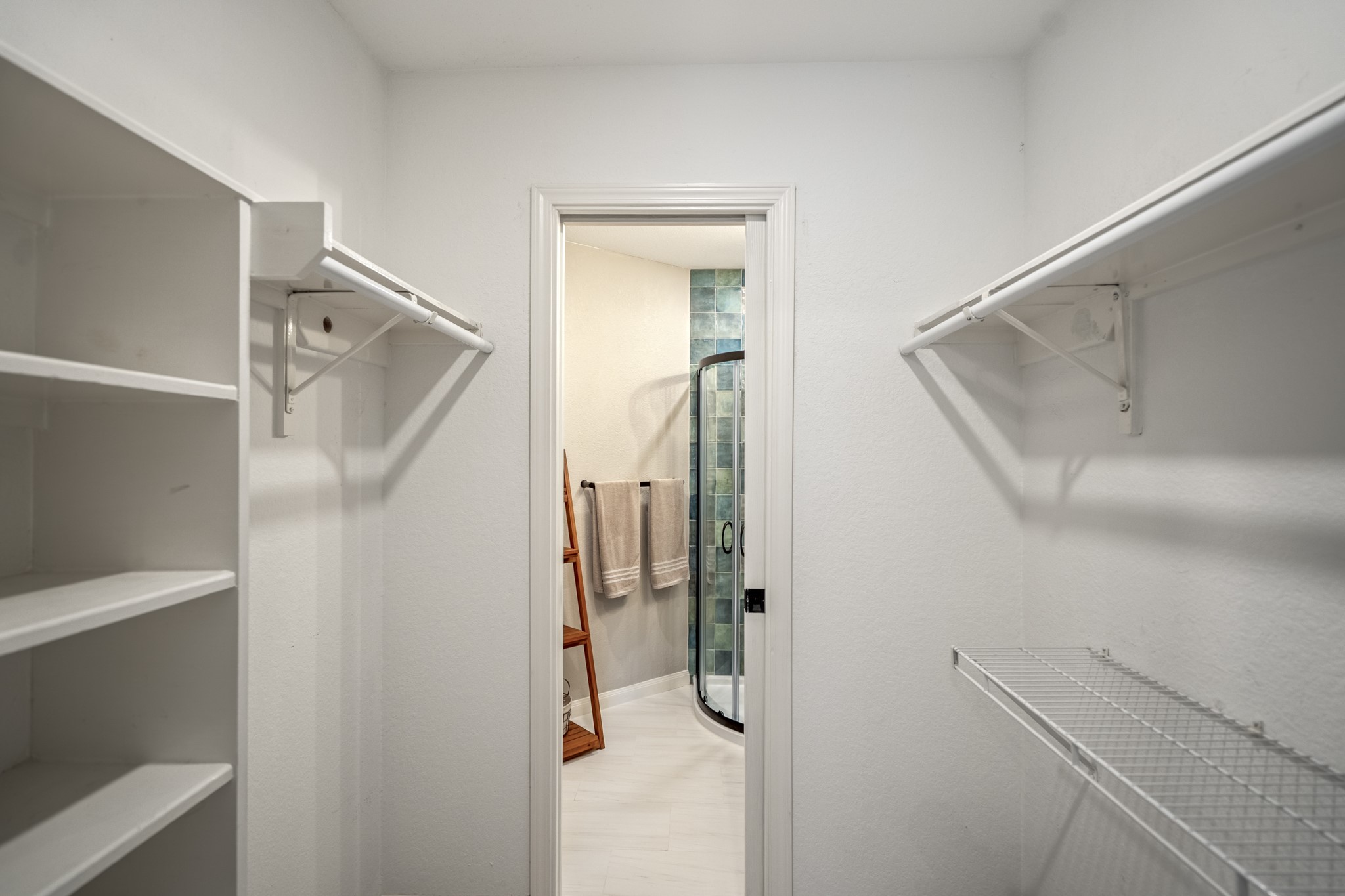 5835 Pinelake Crossing Drive Spring, TX 77379 - Photo 25 of 50 The walk-in closet offers generous hanging space and built-in shelving, thoughtfully connecting through to the ensuite bath for a seamless, private layout.