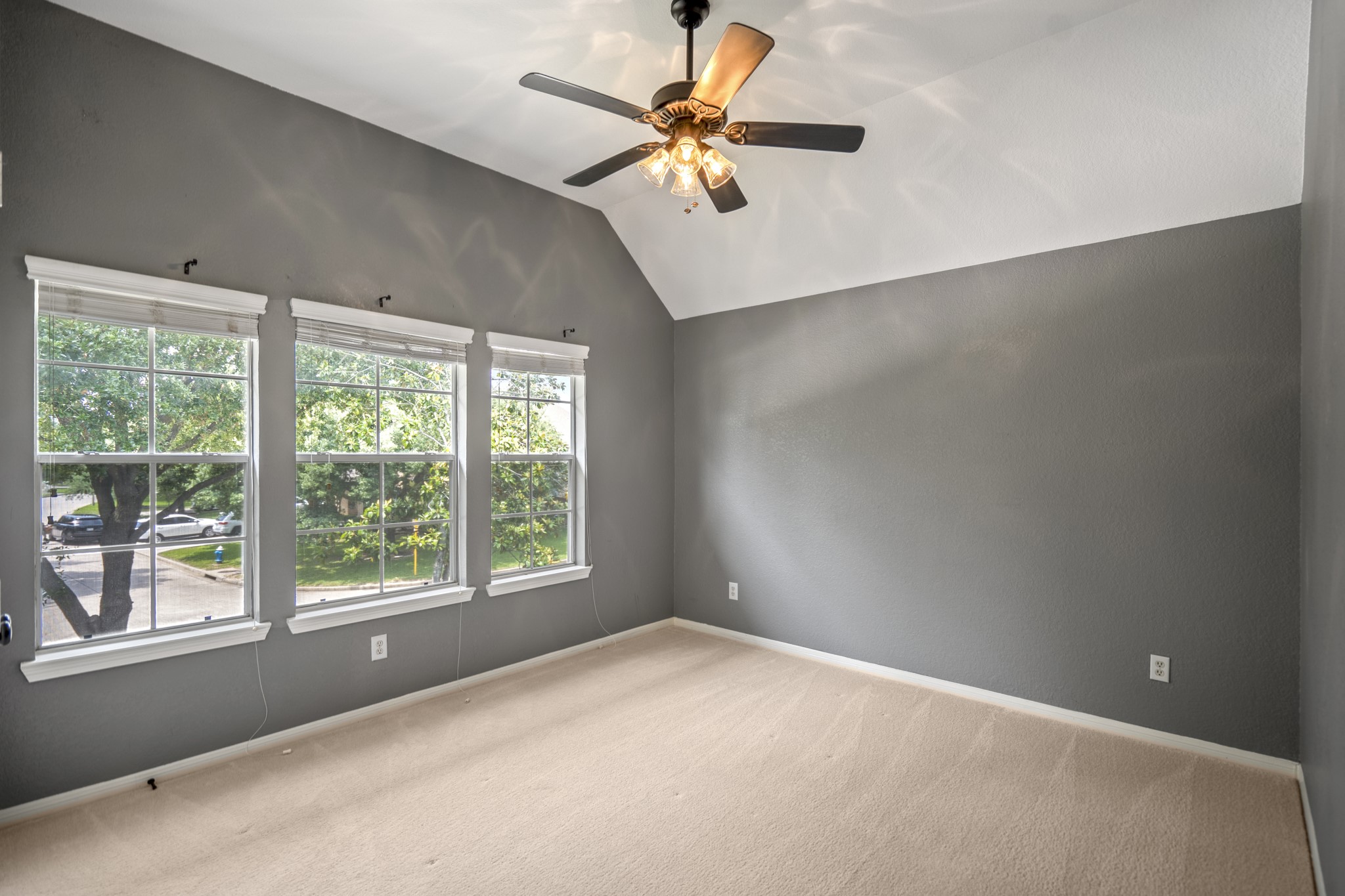 5835 Pinelake Crossing Drive Spring, TX 77379 - Photo 28 of 50 The third upstairs bedroom also overlooks the front of the home, with multiple windows bringing in natural light and a vaulted ceiling that adds to the open feel.