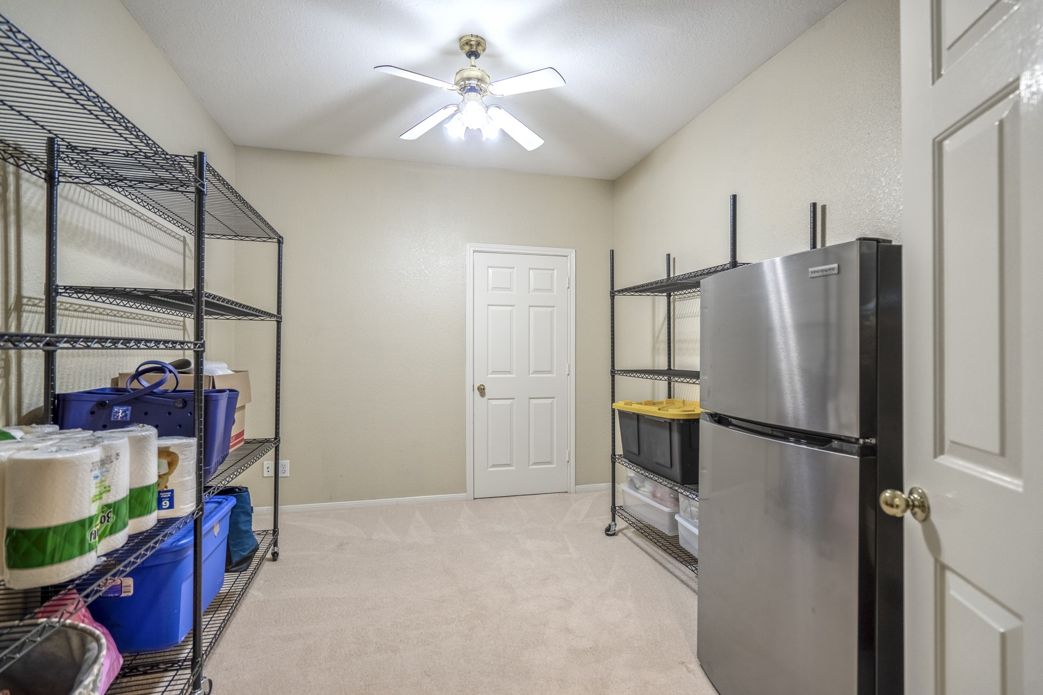 5835 Pinelake Crossing Drive Spring, TX 77379 - Photo 32 of 50 Inside the enclosed storage area, you’ll find a surprisingly spacious, climate-controlled extension of the home—ideal for bulk storage, hobbies, or overflow space. Originally designed as a tandem third-car garage, it now offers flexibility that’s hard to come by, with room to truly spread out and stay organized.