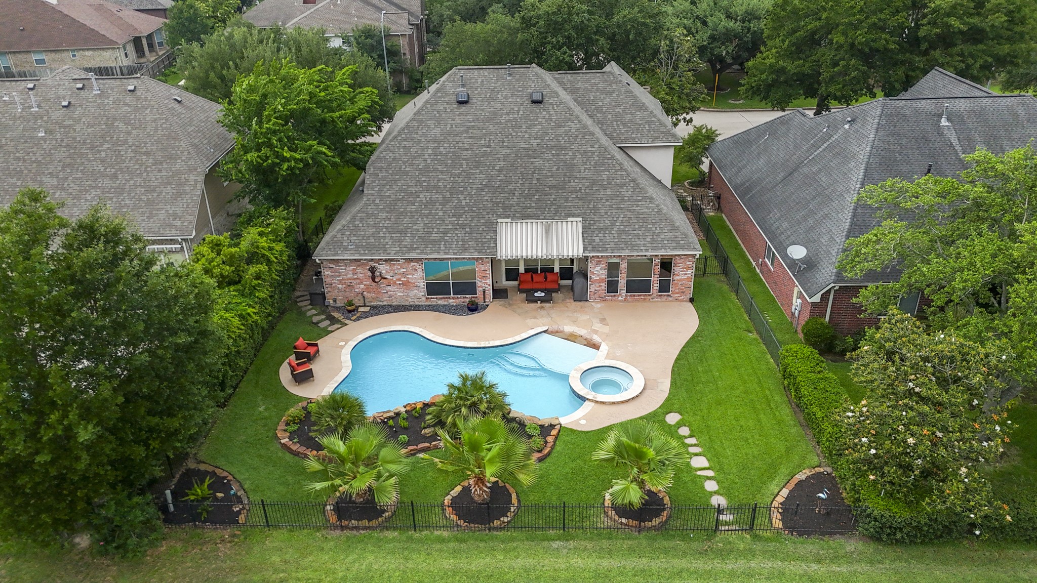 5835 Pinelake Crossing Drive Spring, TX 77379 - Photo 38 of 50 From above, the layout comes into focus—pool, spa, and green space all thoughtfully arranged, with the stepping stone path leading to a rear gate for direct access beyond the fence. A newer roof adds peace of mind, while the setting backs seamlessly to the golf course for an open, unobstructed feel.